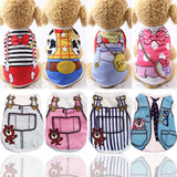 Small dog wearing summer cartoon print vest shirt outside on a sunny day