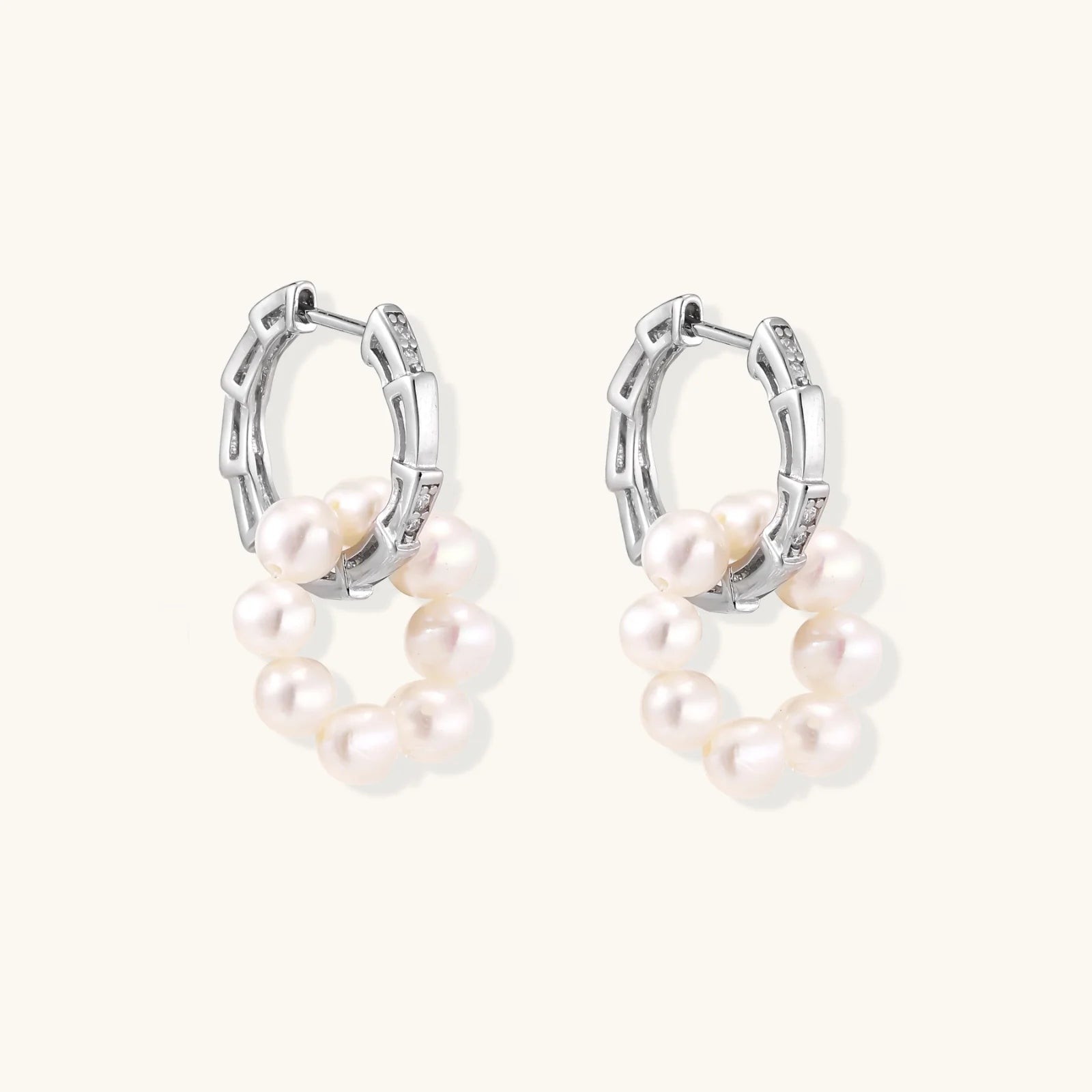 Rhodium-plated silver hoop earrings with freshwater pearls arranged in crescent formation and diamond accents