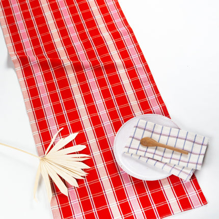 Handwoven Camila plaid table runner in red, pink, and white cotton