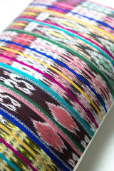 Vintage ikat pillow made from handwoven cotton fabric with multicolor pattern