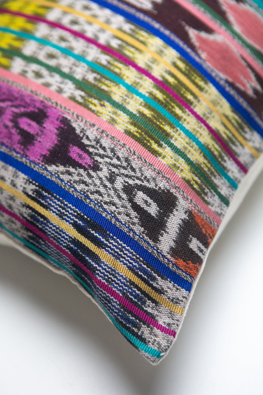 Vintage ikat pillow made from handwoven cotton fabric with multicolor pattern
