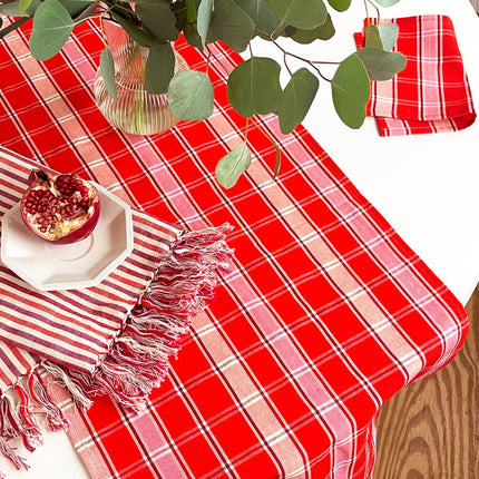Handwoven Camila plaid table runner in red, pink, and white cotton