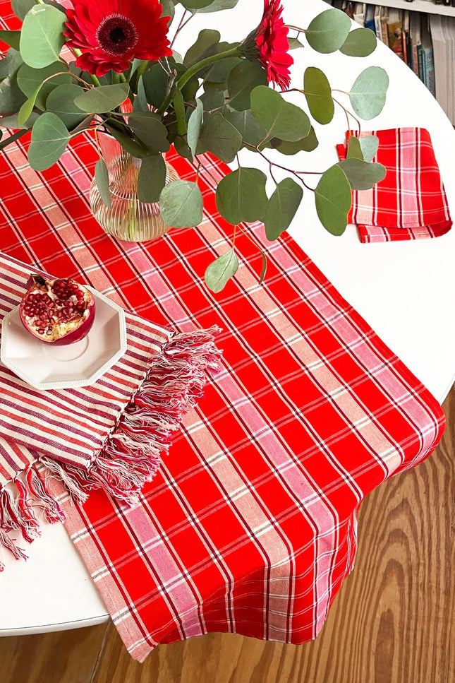 Handwoven Camila plaid table runner in red, pink, and white cotton