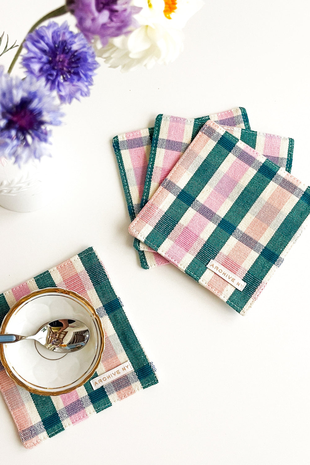 Handwoven multicolor plaid coasters made by artisans in Guatemala