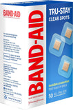 Small square transparent bandage covering minor scrape on finger