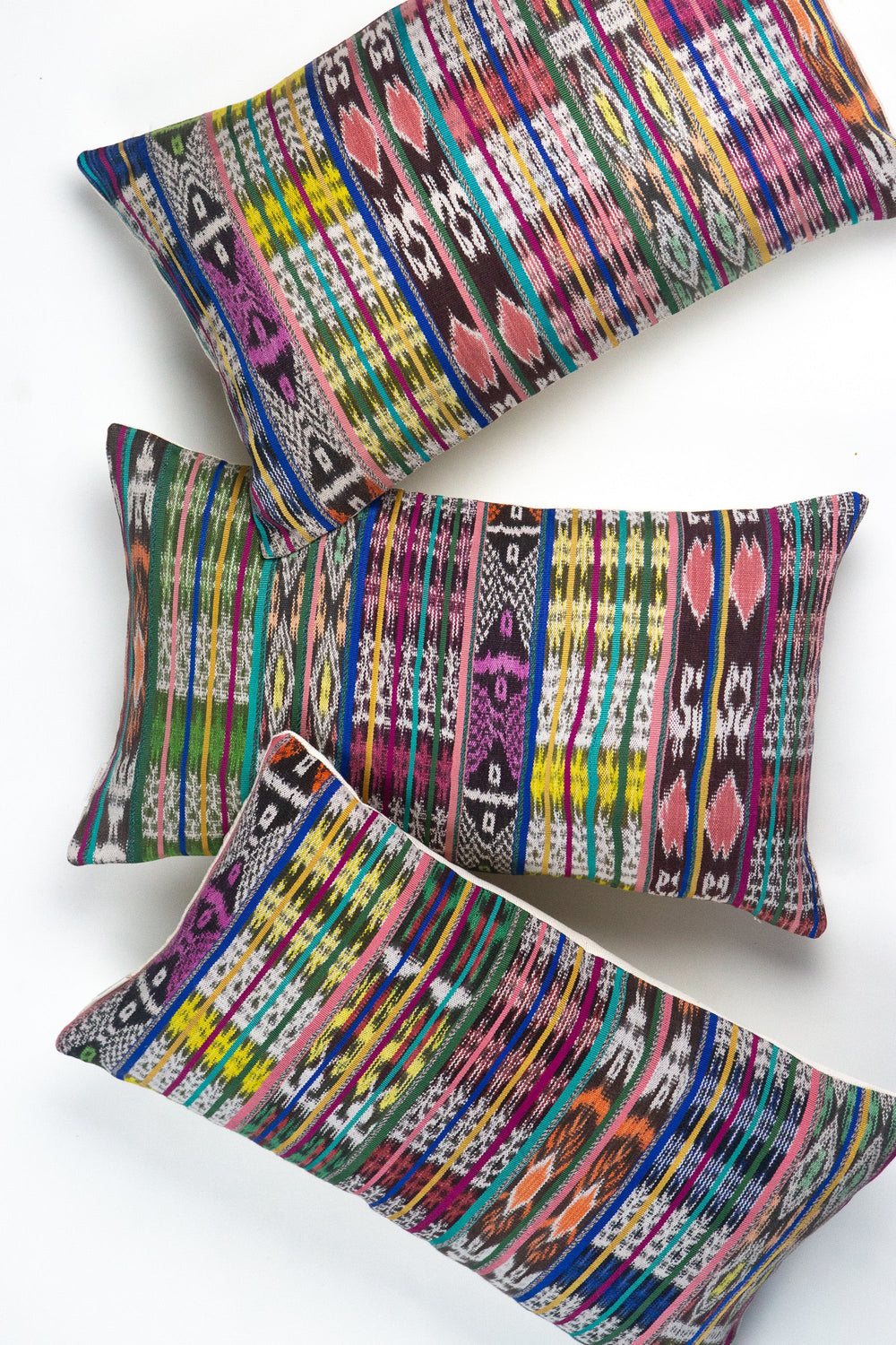 Vintage ikat pillow made from handwoven cotton fabric with multicolor pattern